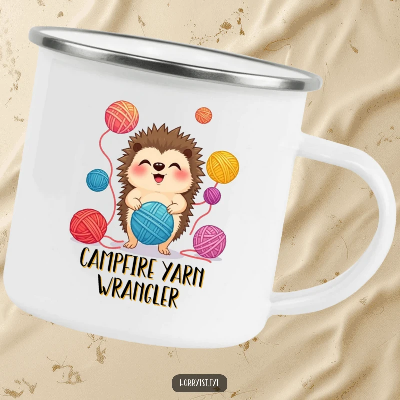 Funny Camping Mug featuring a giggling hedgehog juggling colorful yarn balls, ideal for enjoying crafts outdoors.
