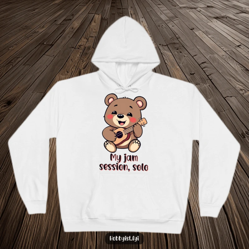 Funny Bear Hoodie: A smiling bear enthusiastically plays a miniature ukulele, offering warmth and humor for any occasion, a fantastic funny gift.