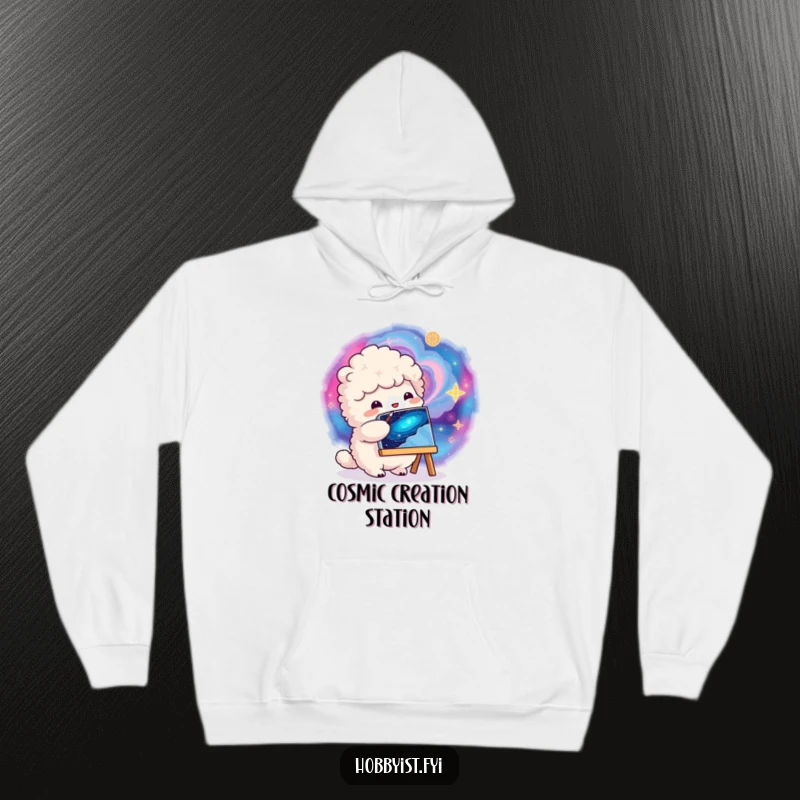 Funny fluffy creature painting a vibrant, swirling galaxy on a small canvas, featured on a warm and cozy hoodie.