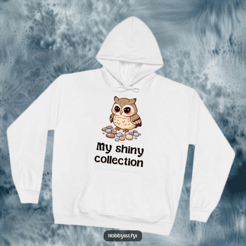 Funny owl hoodie featuring a curious owl meticulously arranging its collection of gleaming pebbles, cozy humor.