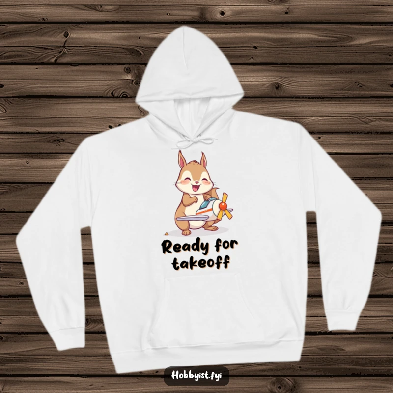 Funny Hoodie designed with a joyful kawaii squirrel happily assembling a small model airplane, perfect for cozy crafting sessions.