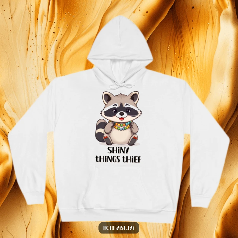 Funny Raccoon Bead Necklace Hoodie, a giggling raccoon concentrating on arranging colorful beads for a necklace, soft and warm.