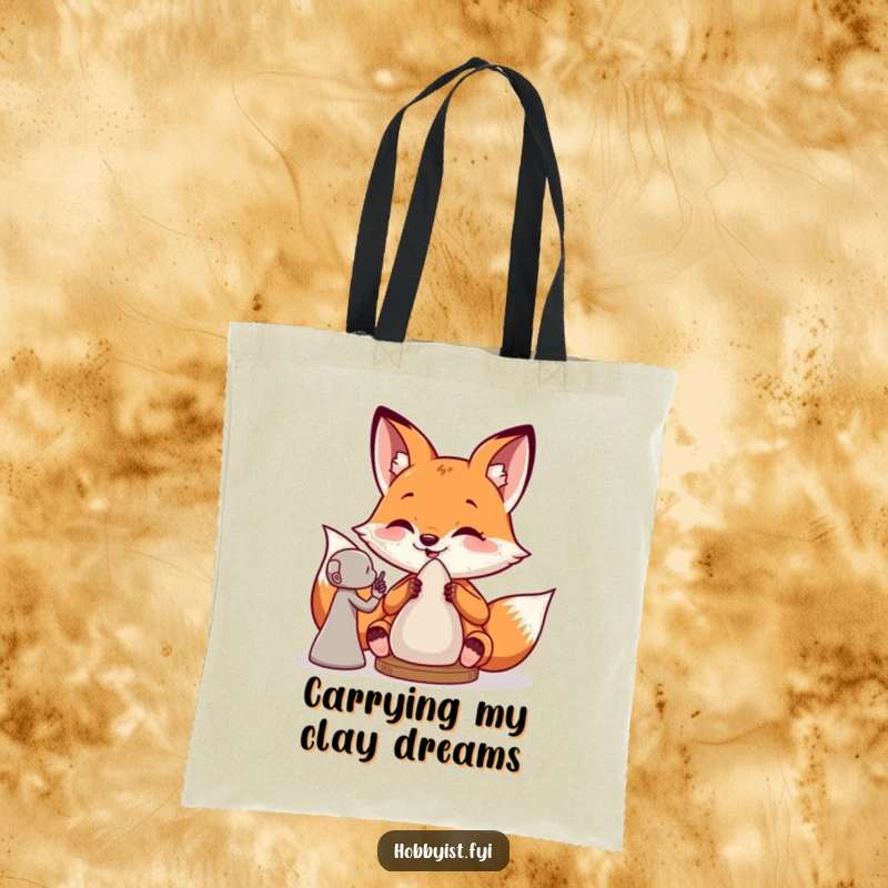 Funny tote bag featuring a giddy fox artist creating a clay sculpture, practical for carrying supplies with a touch of humor.